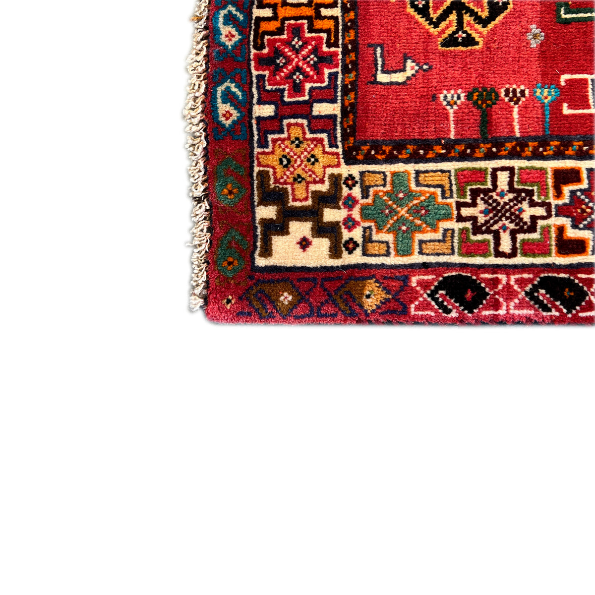 Qashqai rug edge with fringe and multicolored ornaments along the border