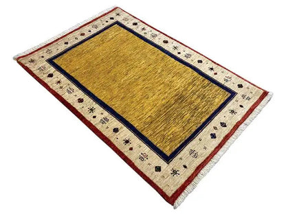 Rug with yellow central motif, blue border, and red trim, 121x81 cm
