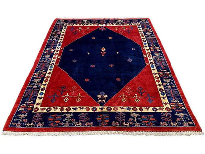 Rectangular rug with a blue center, red border, and decorative edging