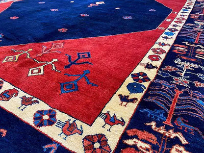 Carpet detail: blue center, red field, and border strip with ornaments