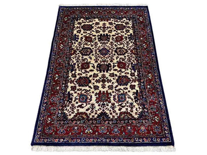 Rug with an oriental pattern, beige background, dark blue and red, fringed edge