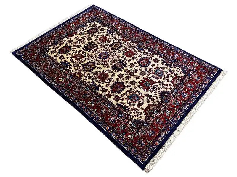 Rug in a reclining format with an oriental ornamental pattern, beige central area, blue-red border