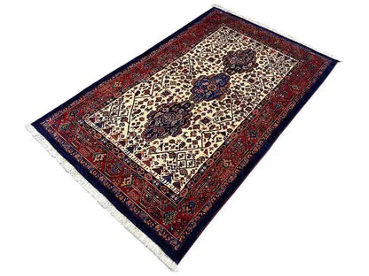 Qashqai rug in diagonal view, dark blue outer border with a red ornamental border