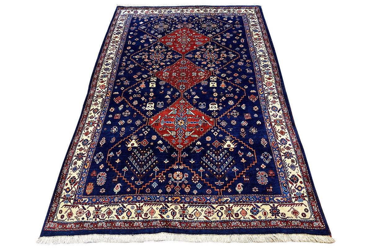 Blue oriental rug with a central red medallion and ornamental details, with fringes.