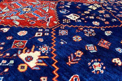 Close-up: blue carpet with colorful geometric patterns in the pile.