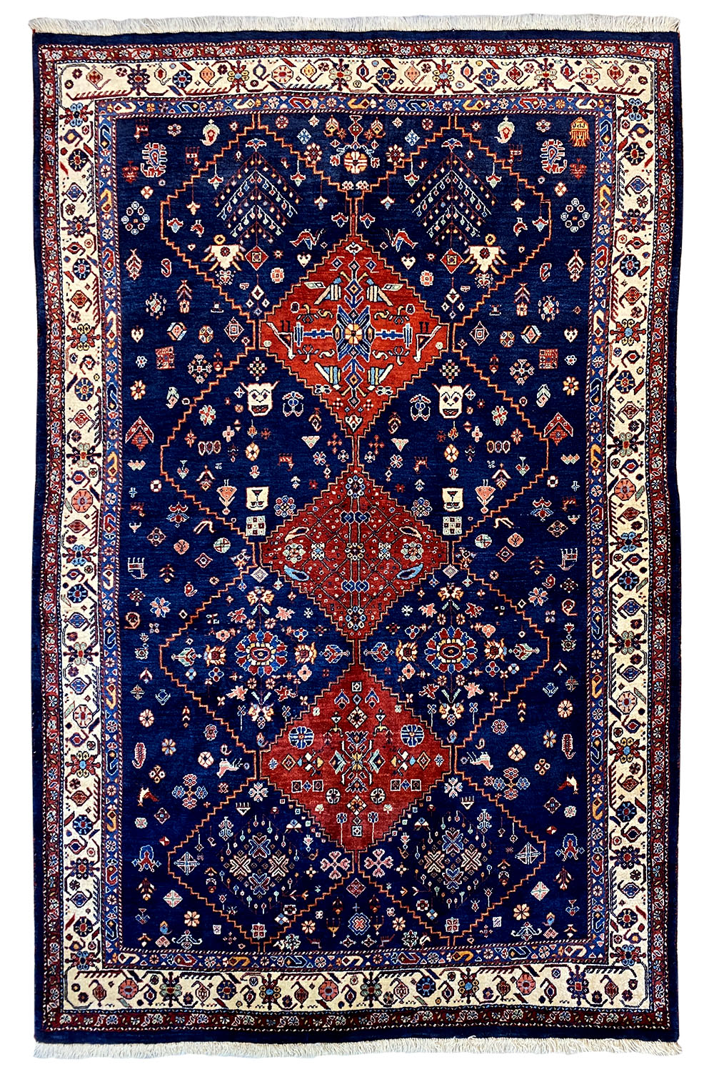 Blue Oriental rug with a red medallion and ornamental border, with fringes.
