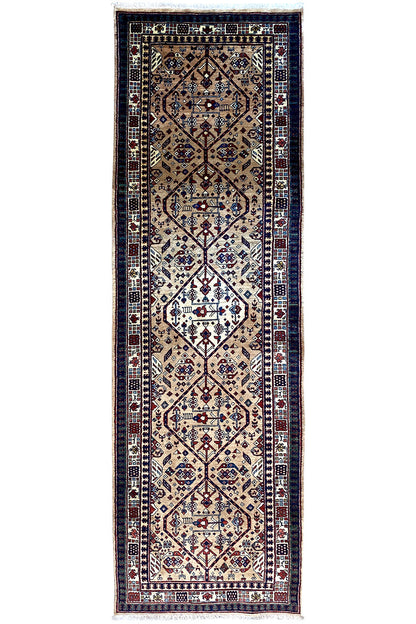 Rug with a blue border, beige and dark blue medallion pattern, and fringes