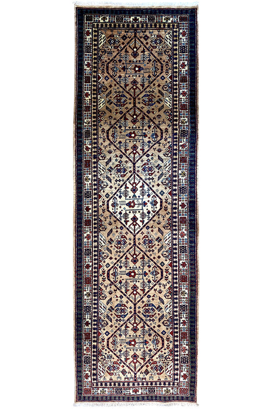 Rug with a blue border, beige and dark blue medallion pattern, and fringes