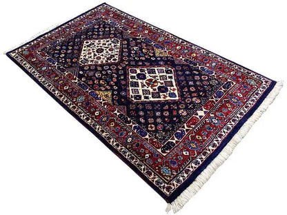 Rug with dark blue and red border design, multiple medallions, fringes