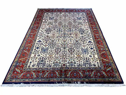 Oriental rug with a light central field and red border, rectangular