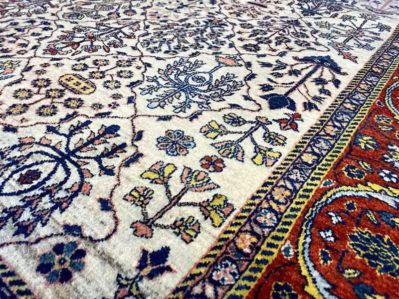Close-up of an ornamental pattern: cream, blue, yellow and red with a colored border