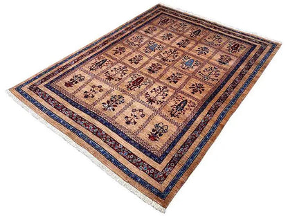 Rug laid out with a beige background and dark blue border trim