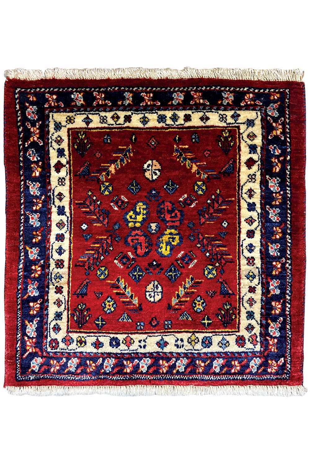 Square red Oriental rug with a blue border, beige central medallion, and fringes