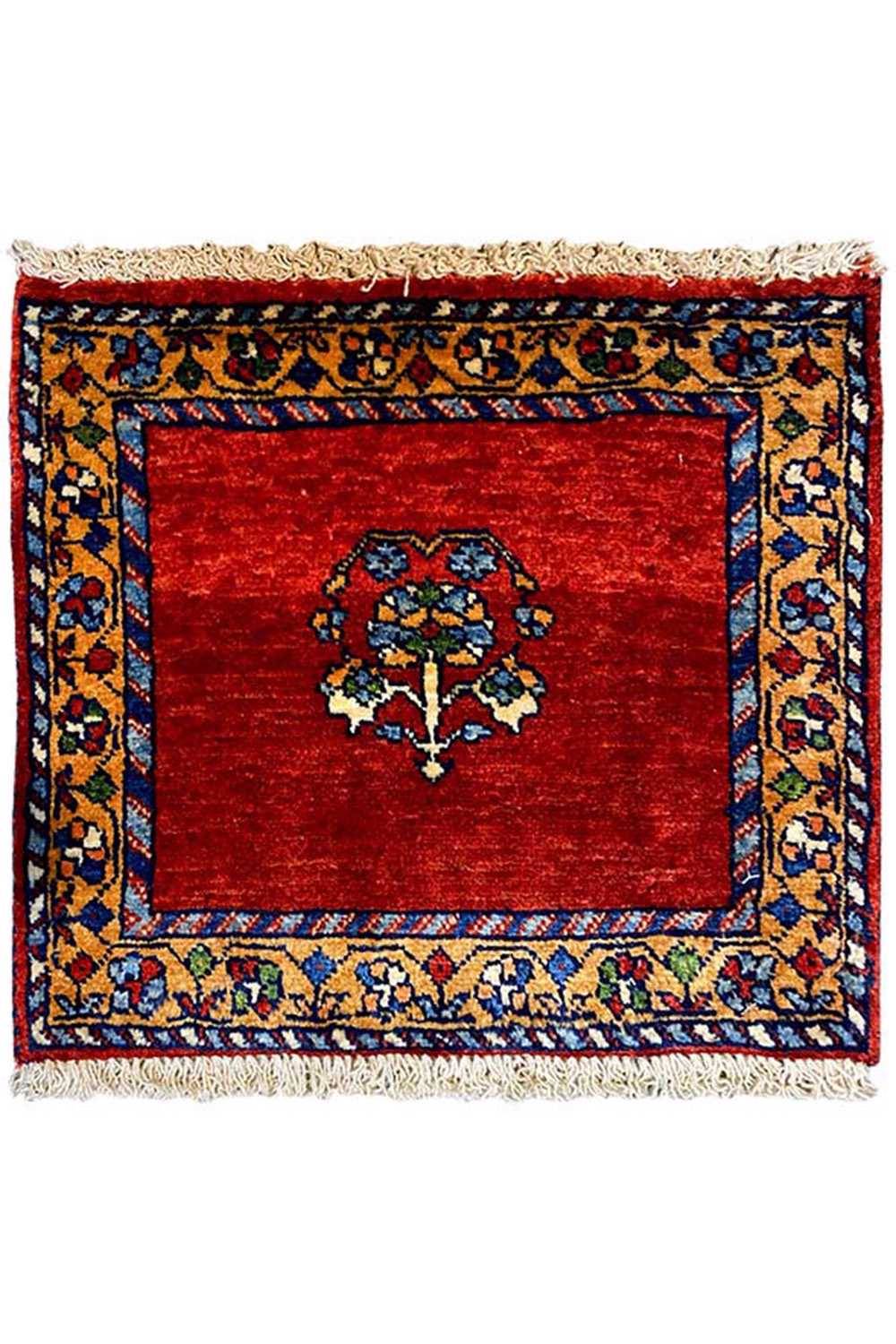 Square rug with a red field, blue border pattern, and fringes on all sides