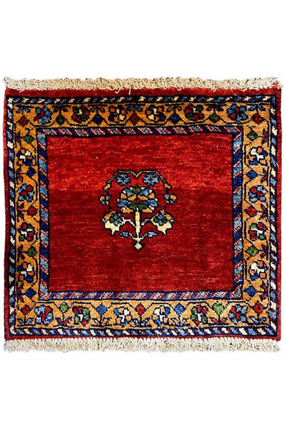 Square rug with a red field, blue border pattern, and fringes on all sides