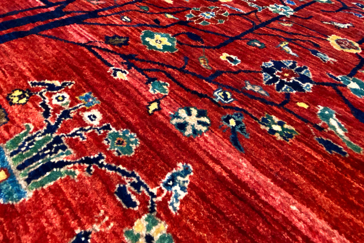 Close-up: red carpet with colorful floral and ornamental patterns