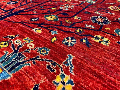 Close-up: red carpet with blue-yellow-red ornaments and a fine woven pattern
