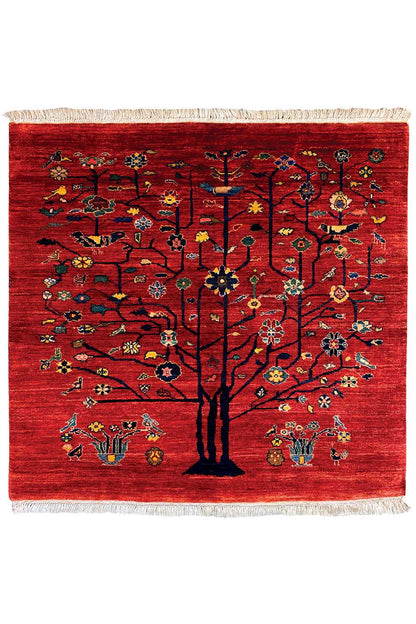 Red Oriental rug with a central tree motif, colorful designs, and fringes on all sides