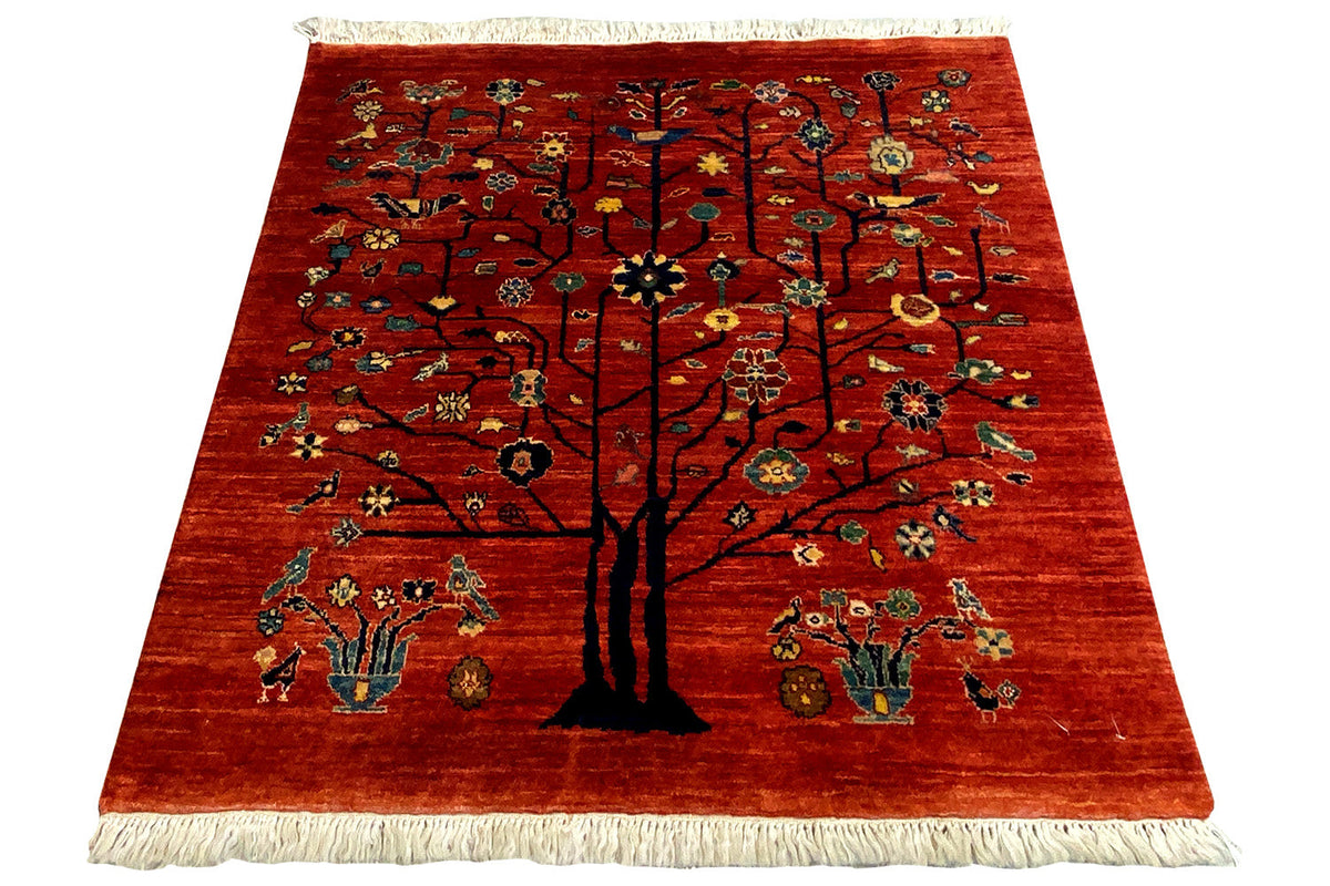 Qashqai rug with a tree motif on a red background, fringes all around