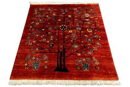 Qashqai rug with a tree motif on a red background, fringes all around
