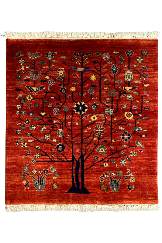 Qashqai rug with tree motif, red background, and fringes