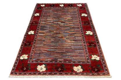 Rectangular rug with a red border, multicolored stripes, and floral medallions