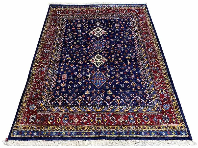 Blue-red Oriental rug with a geometric medallion and fringes