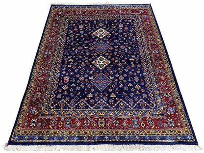 Blue-red Oriental rug with a geometric medallion and fringes