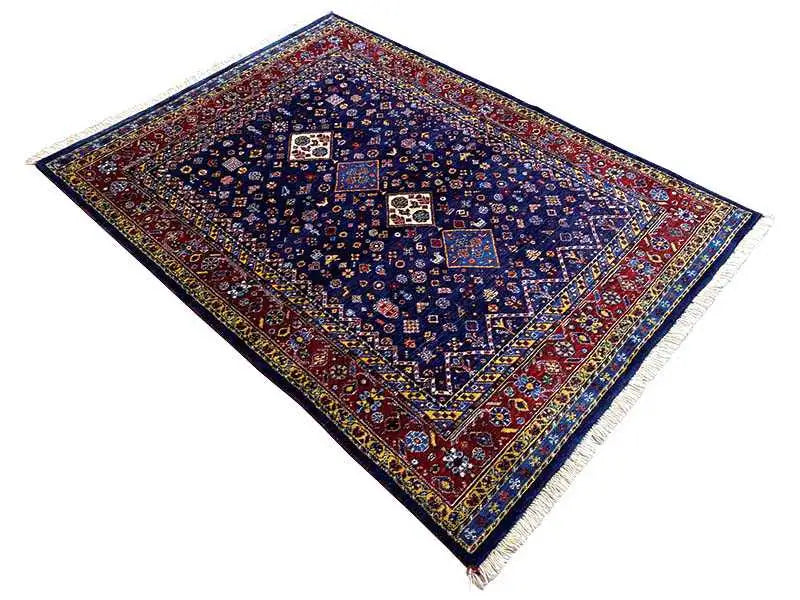Dark blue oriental rug, diagonal, with a red border and medallion patterns