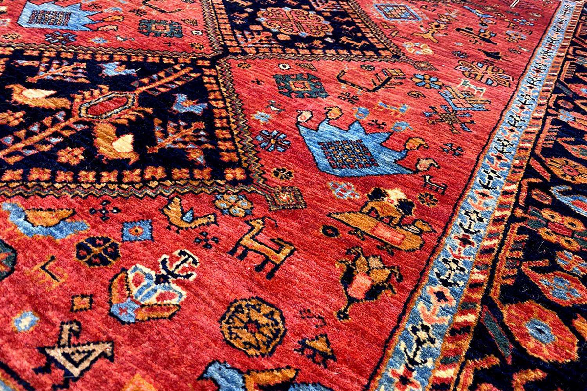 Close-up: red carpet with colorful patterns and a blue border stripe