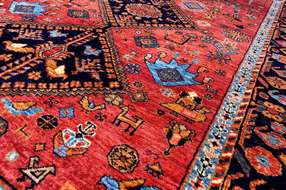 Close-up: red carpet with colorful patterns and a blue border stripe