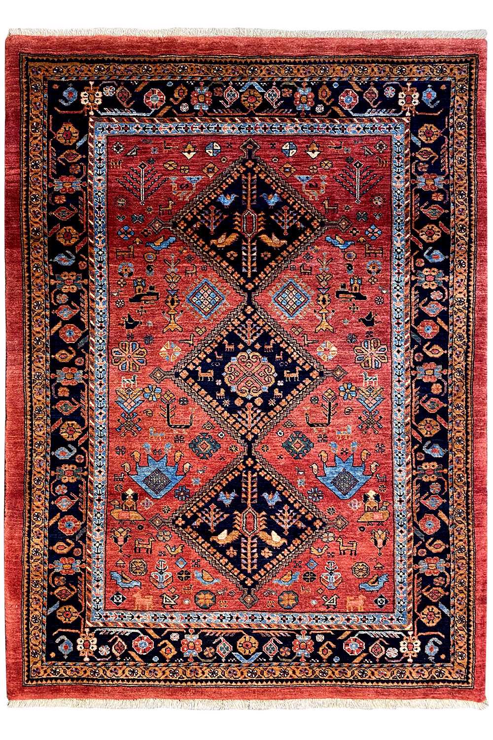 Rectangular rug with a red field, blue-black border, and diamond medallion