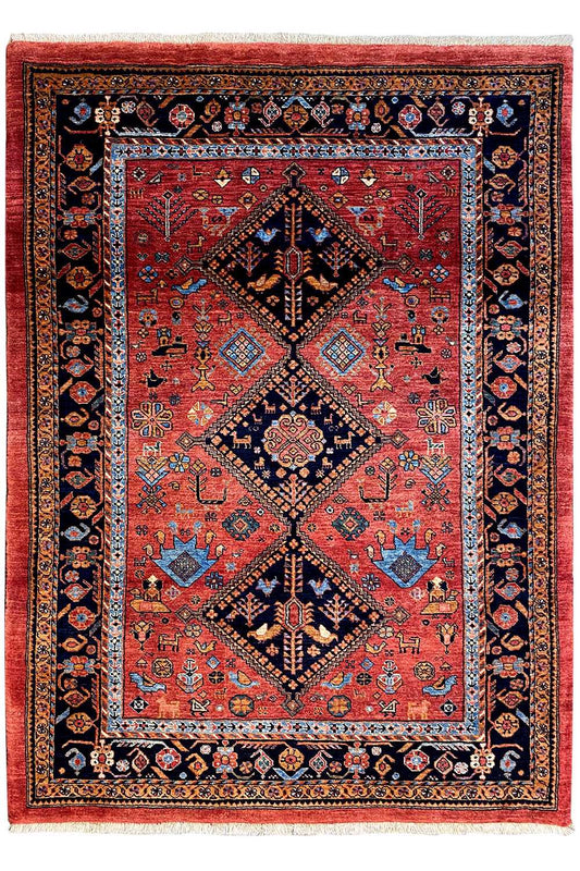 Rectangular rug with a red field, blue-black border, and diamond medallion