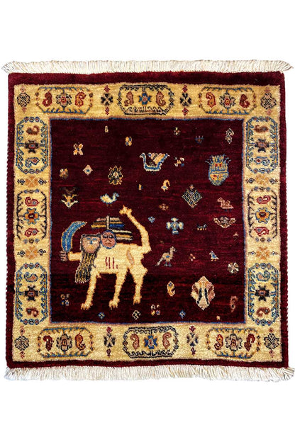 Square rug with a red background, a central animal motif, and a decorative border