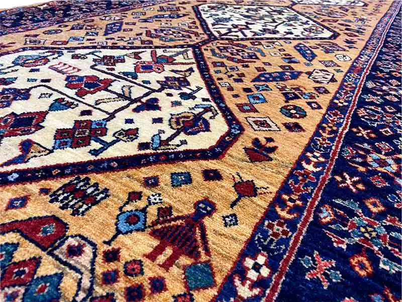Runner rug detail view: fine patterns and lines in gold, dark blue, and red