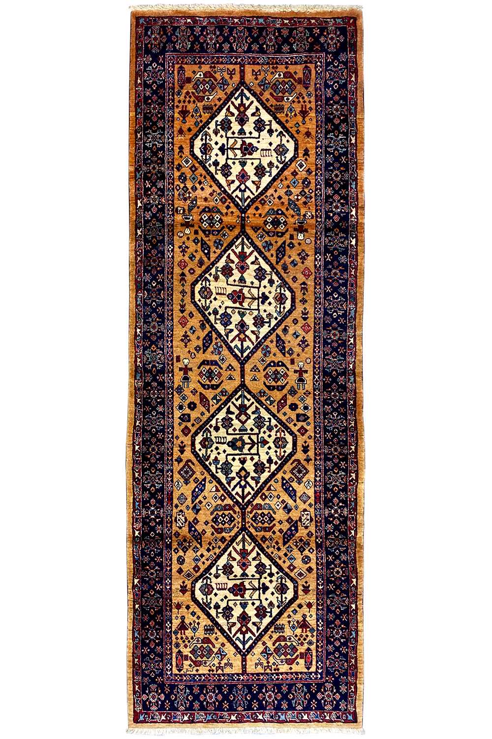 Runner rug front view with a vertical vine and diamond pattern in gold and dark blue