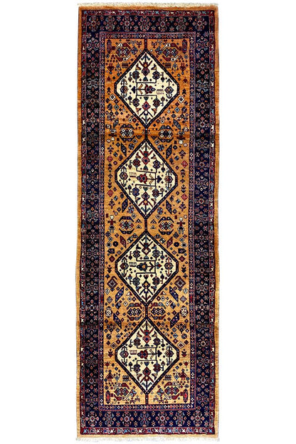 Runner rug front view with a vertical vine and diamond pattern in gold and dark blue
