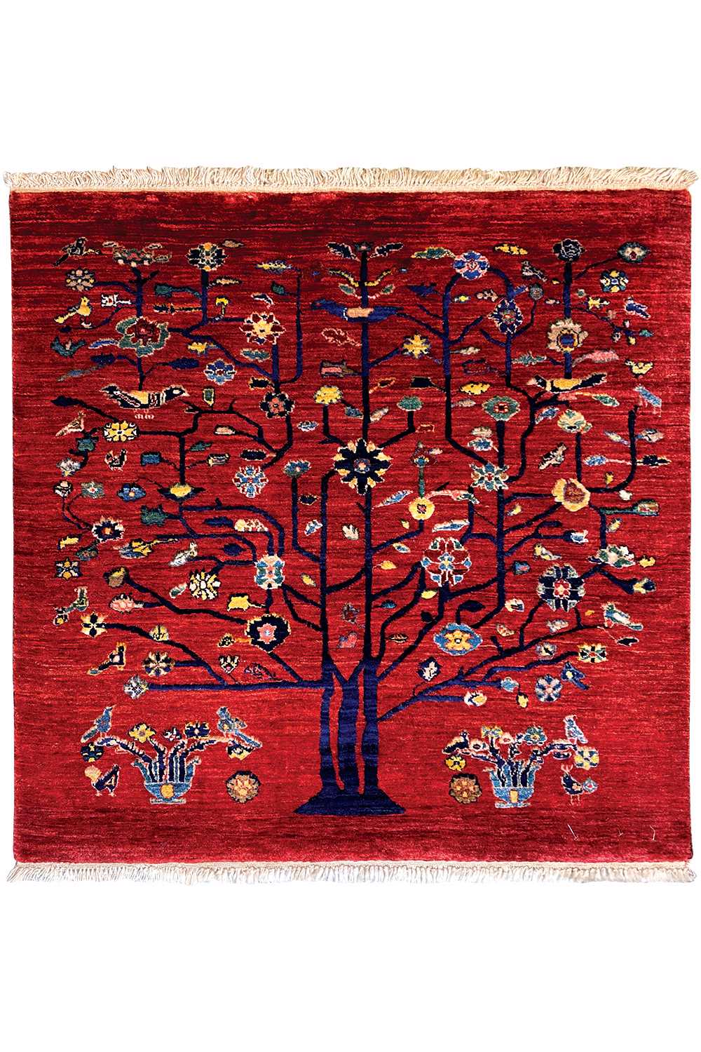 Red Oriental rug with a symmetrical tree motif, a wide ornamental border, and fringes