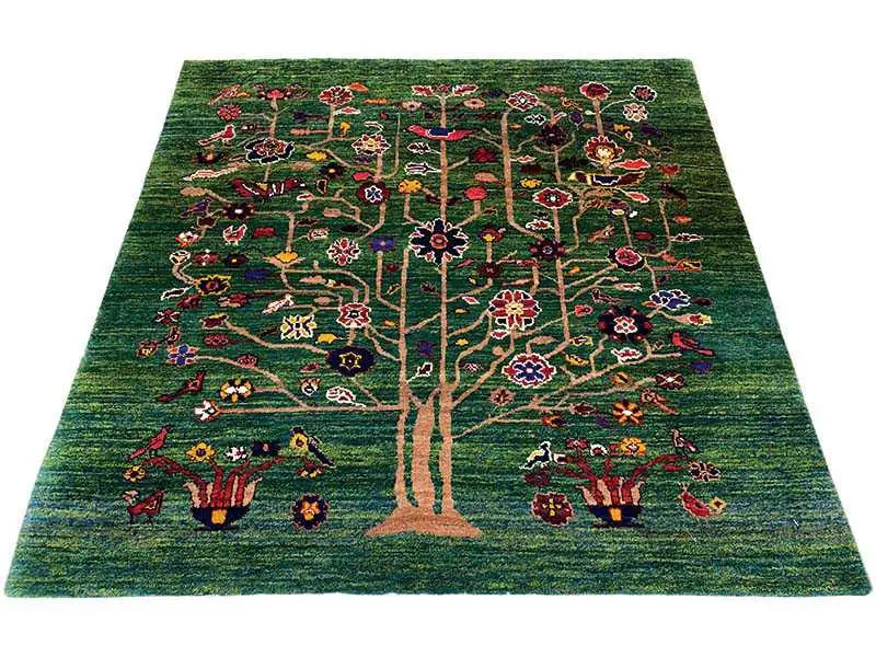 Green oriental rug with a tree motif and colorful flowers, rectangular
