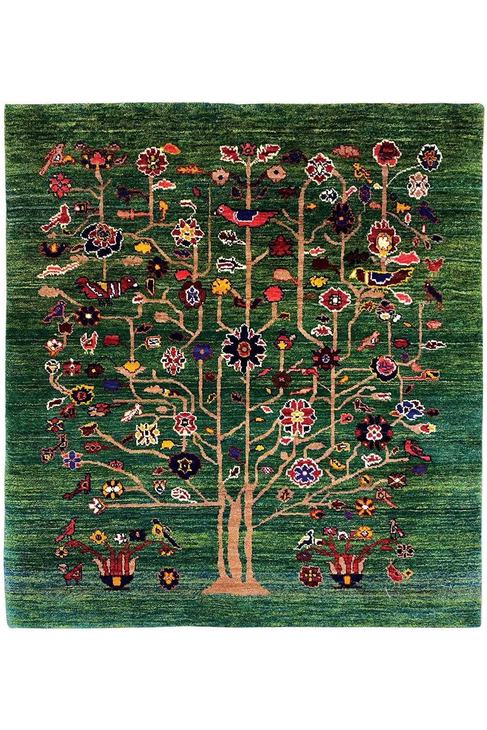 Green Oriental rug with a central tree motif, colorful flowers, and red accents