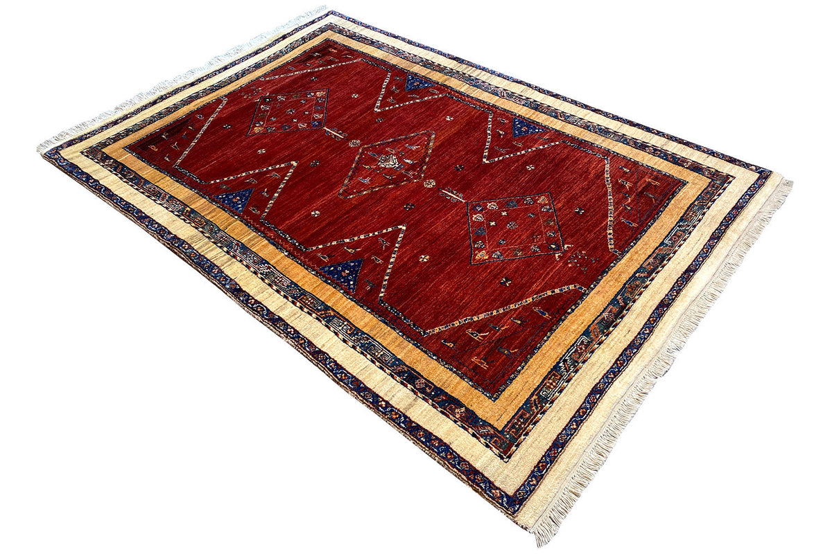 Rug 200x135 cm with a red center, wide blue border, diagonal ornamentation, tassels