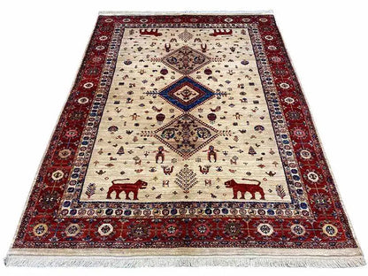 Qashqai exclusive rug, cream-colored with a red border and ornaments, fringes