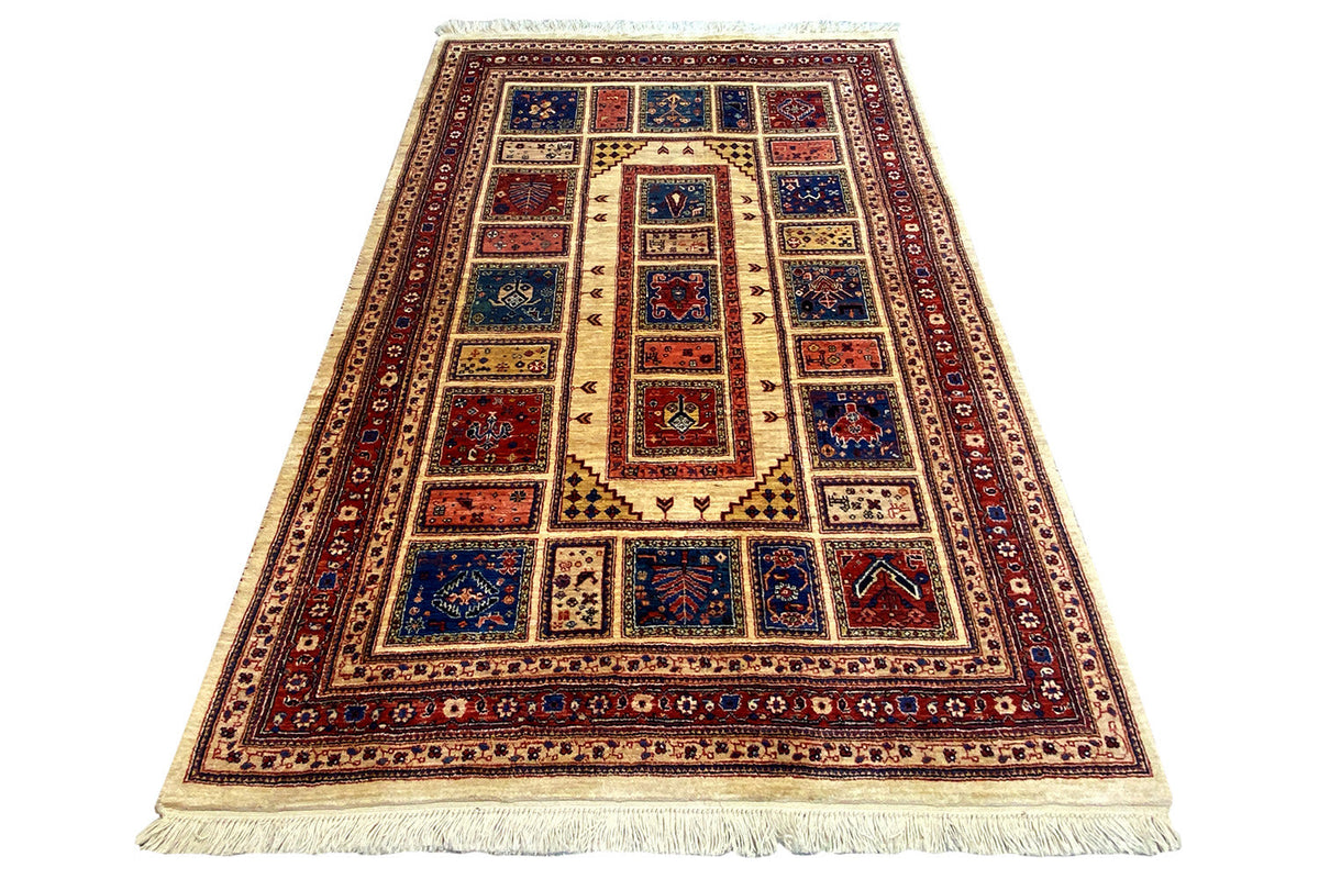 Oriental rug in a vertical format with a red border, blue center, and fringes
