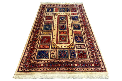 Oriental rug in a vertical format with a red border, blue center, and fringes