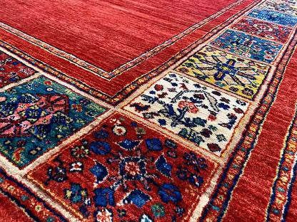 Close-up: red carpet with a blue ornamental field and multicolored border