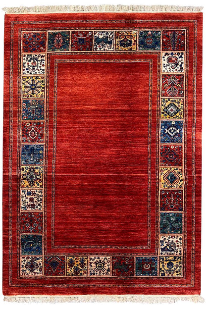 Rectangular red rug with a blue tiled border and white fringes
