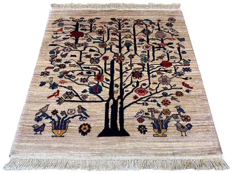 Beige rug with a large tree motif, colorful birds and flowers, and fringes on all sides.