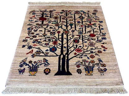 Beige rug with a large tree motif, colorful birds and flowers, and fringes on all sides.