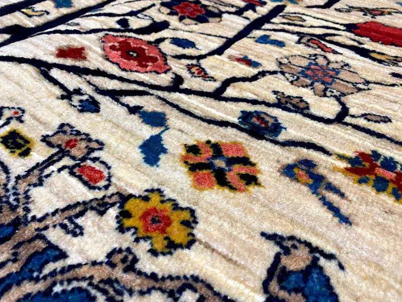 Close-up: beige carpet with a colorful ornamental pattern, featuring blue, red, and yellow details.