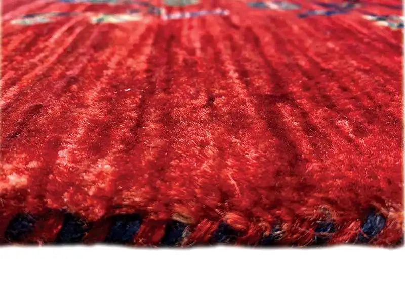 Red carpet with a dense pile and delicate pattern, close-up of the surface.